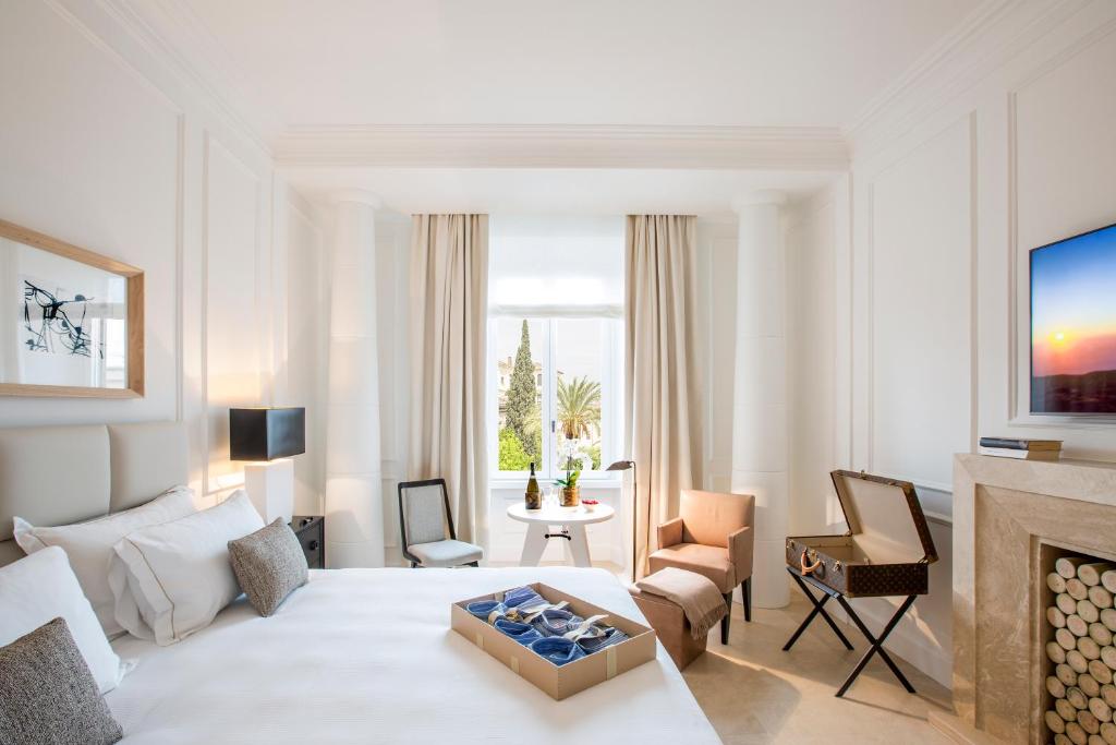 a white living room with a couch and a fireplace at Residenza B in Rome