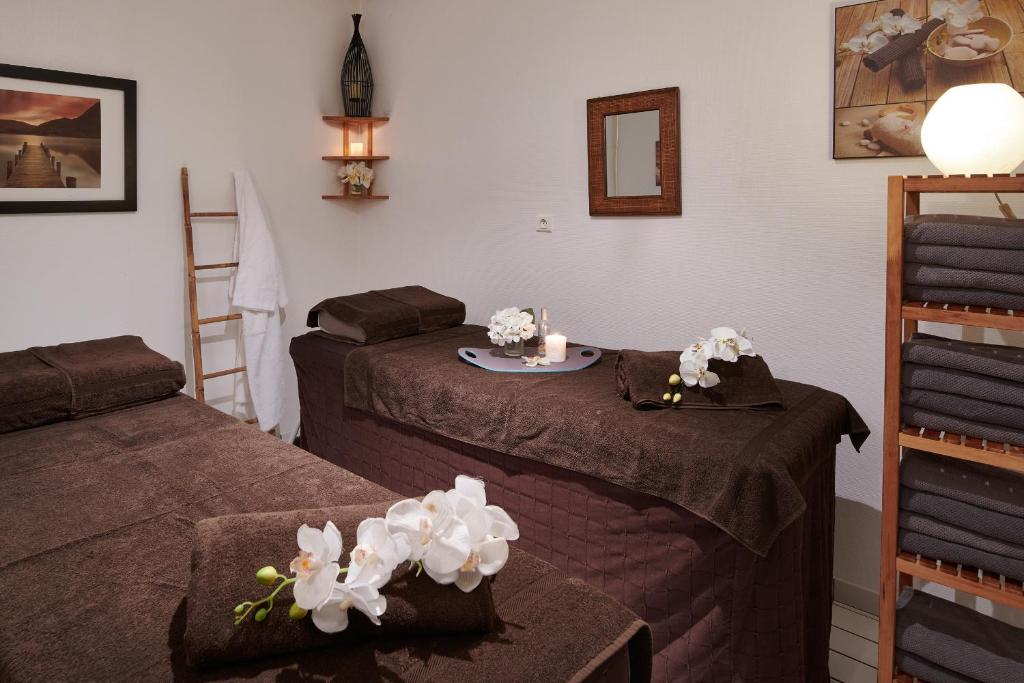 Cama ou camas em um quarto em Club Vacances Bleues Les Jardins De l'Atlantique