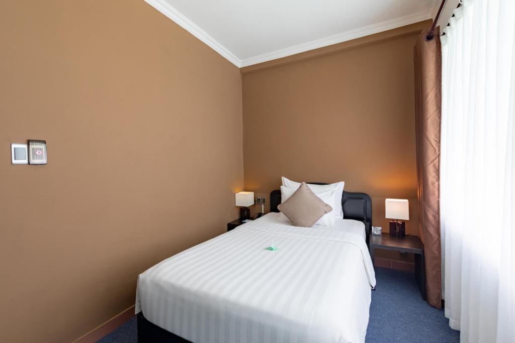 Postel nebo postele na pokoji v ubytování Grandvrio City Danang By Route Inn Group