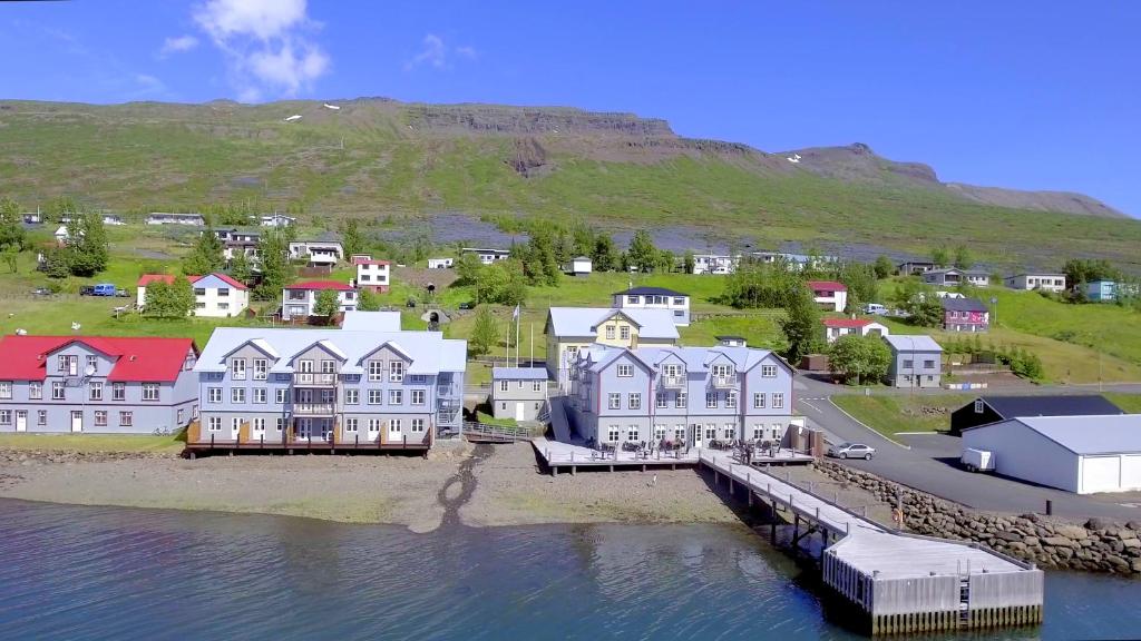 a group of houses on the shore of a body of water at Fosshotel Eastfjords in Fáskrúðsfjörður