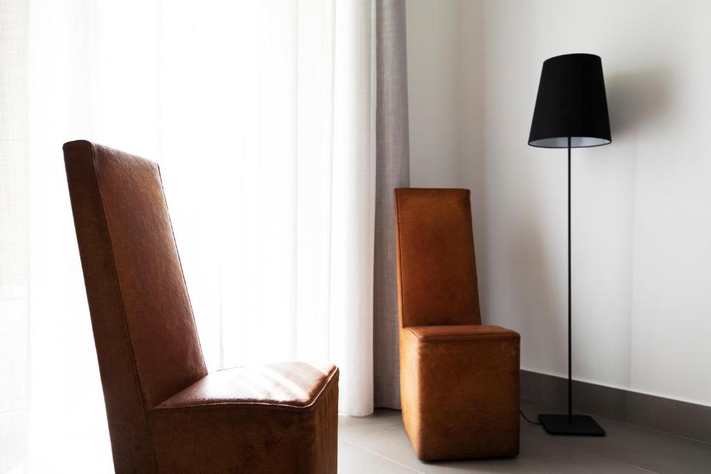 a room with two chairs and a lamp and a window at Acate81 Lifestyle Apartment in Naples