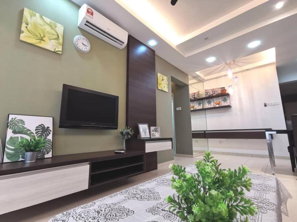 a living room with a flat screen tv and a board at Menjalara Kepong Desapark & PJ 中文房东 B12 in Kuala Lumpur