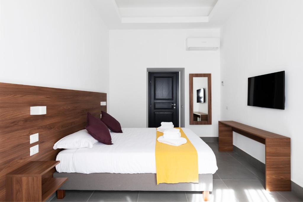 a bedroom with a large bed and a tv at Acate81 Lifestyle Apartment in Naples