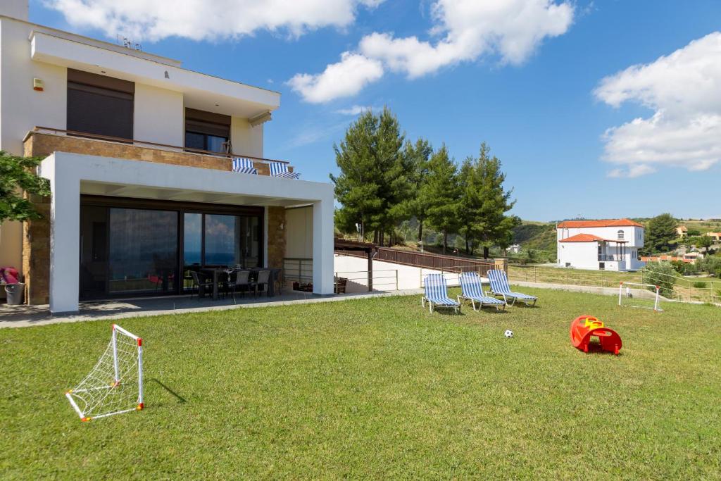 a house with a soccer ball in the yard at Villa Rossa in Hanioti