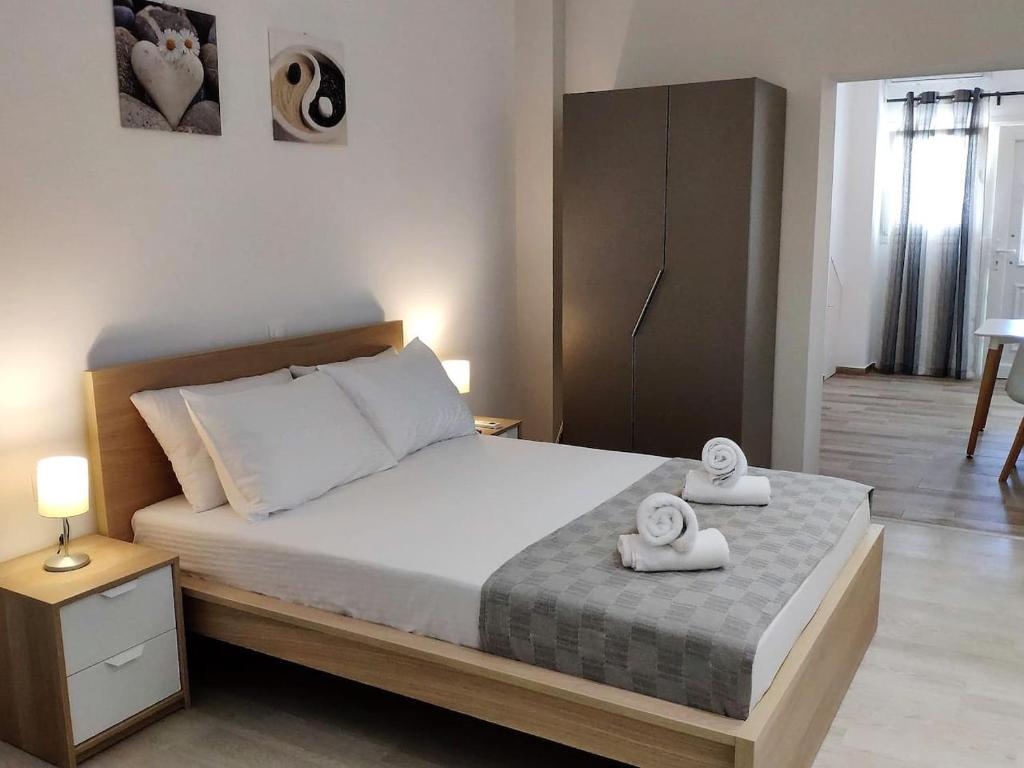 a bedroom with a bed with two towels on it at Neva Apartments by the Beach in Makry Gialos
