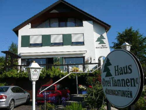 a house with a sign in front of it at Haus Drei Tannen in Schieder-Schwalenberg