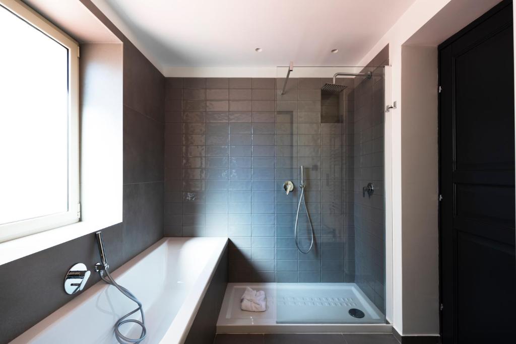 a bathroom with a bath tub and a shower at Acate81 Lifestyle Apartment in Naples