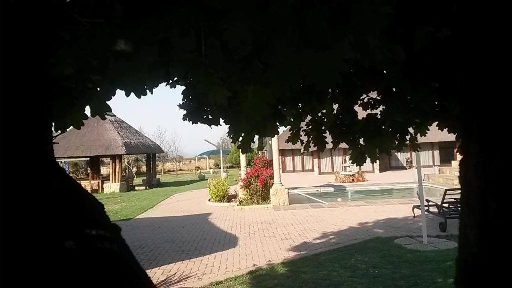 a gazebo and a pavilion in a yard at Stone Hounds Lodge in Magaliesburg