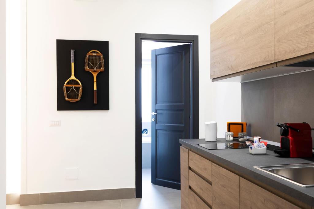 a kitchen with a blue door and a kitchen counter at Acate81 Lifestyle Apartment in Naples