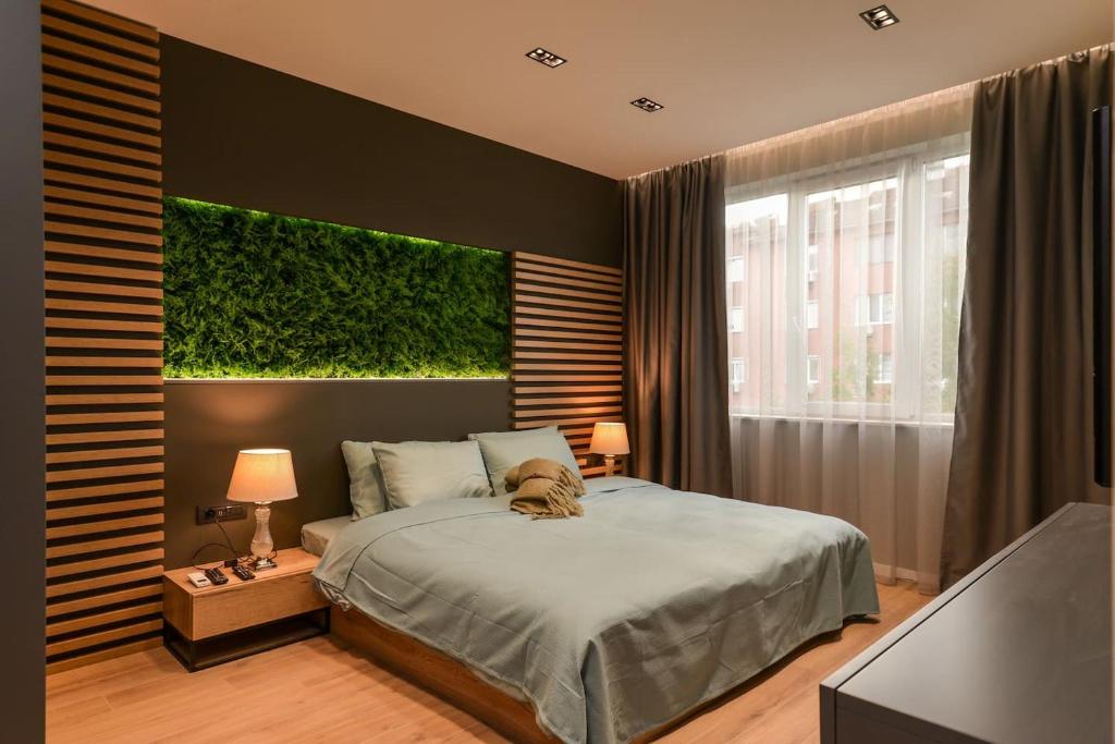 a bedroom with a bed with a green wall at Urban Eden - LUX & STYLE, 2-Bedroom, 2-Bathroom in Sofia