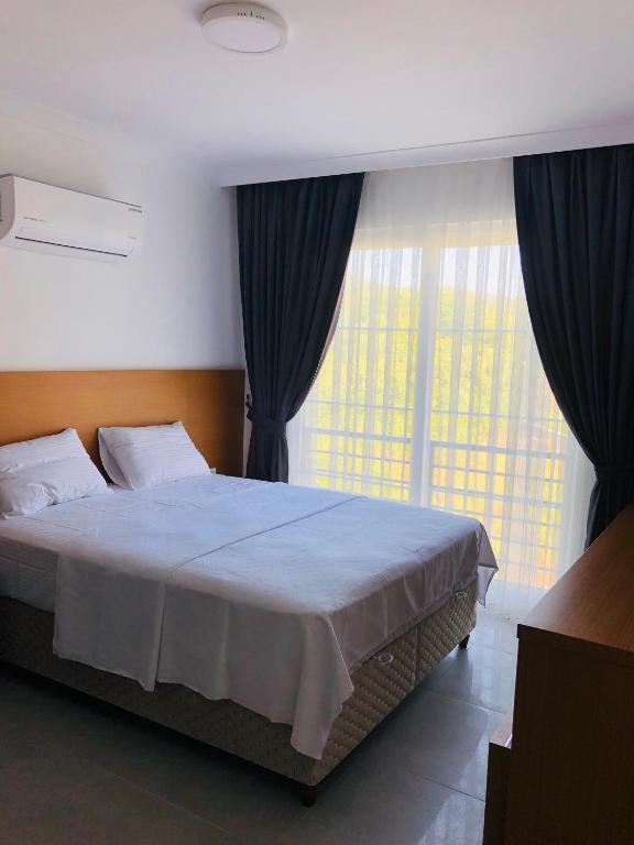 Postel nebo postele na pokoji v ubytování AdaHan Family Rooms Gocek