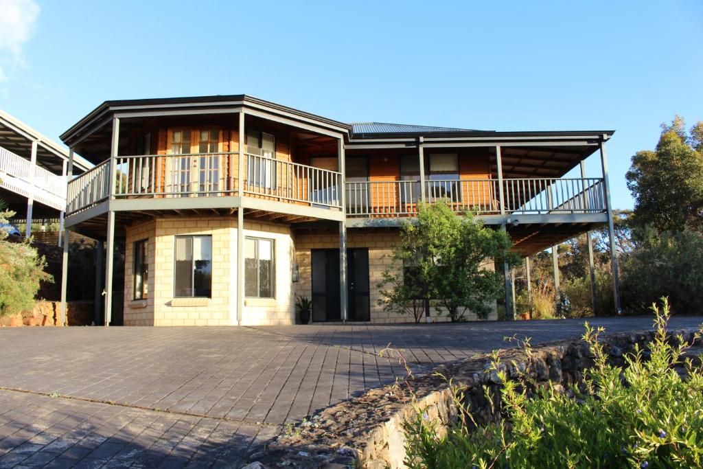 a large house with a balcony and a driveway at Waterside View in Augusta