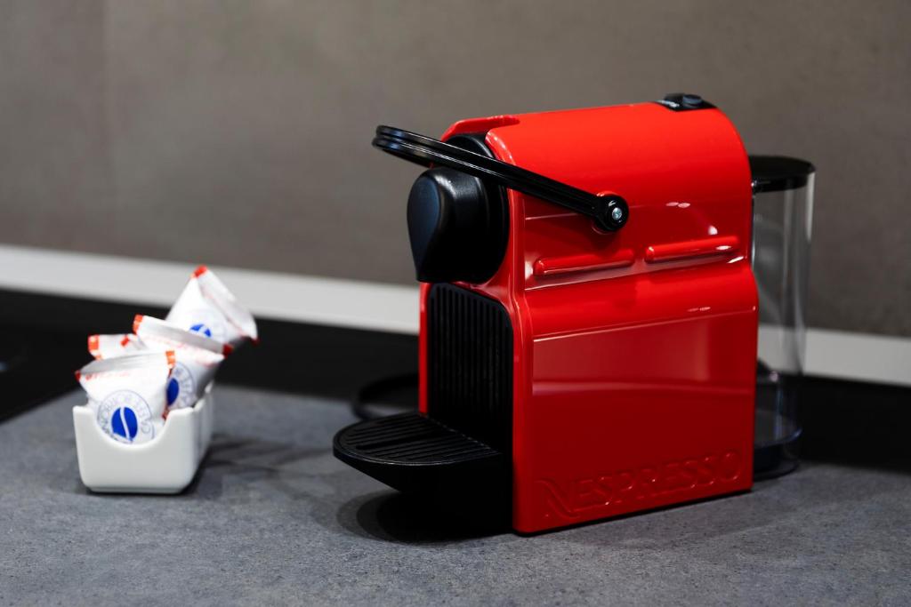 a red toaster sitting on top of a counter at Acate81 Lifestyle Apartment in Naples