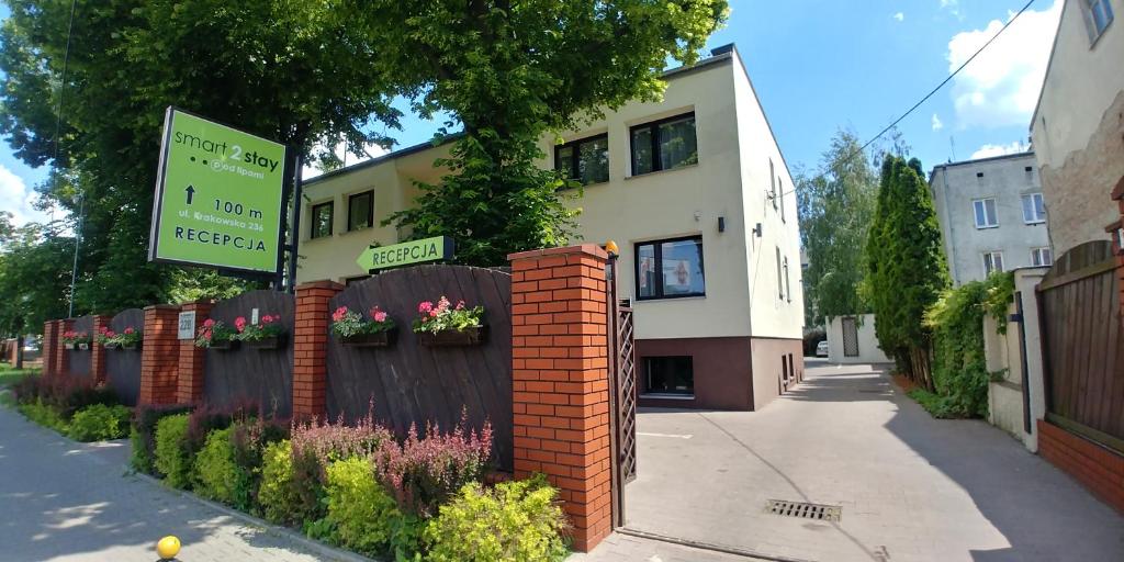 a building with a sign on the side of a street at Smart2Stay Pod Lipami in Warsaw