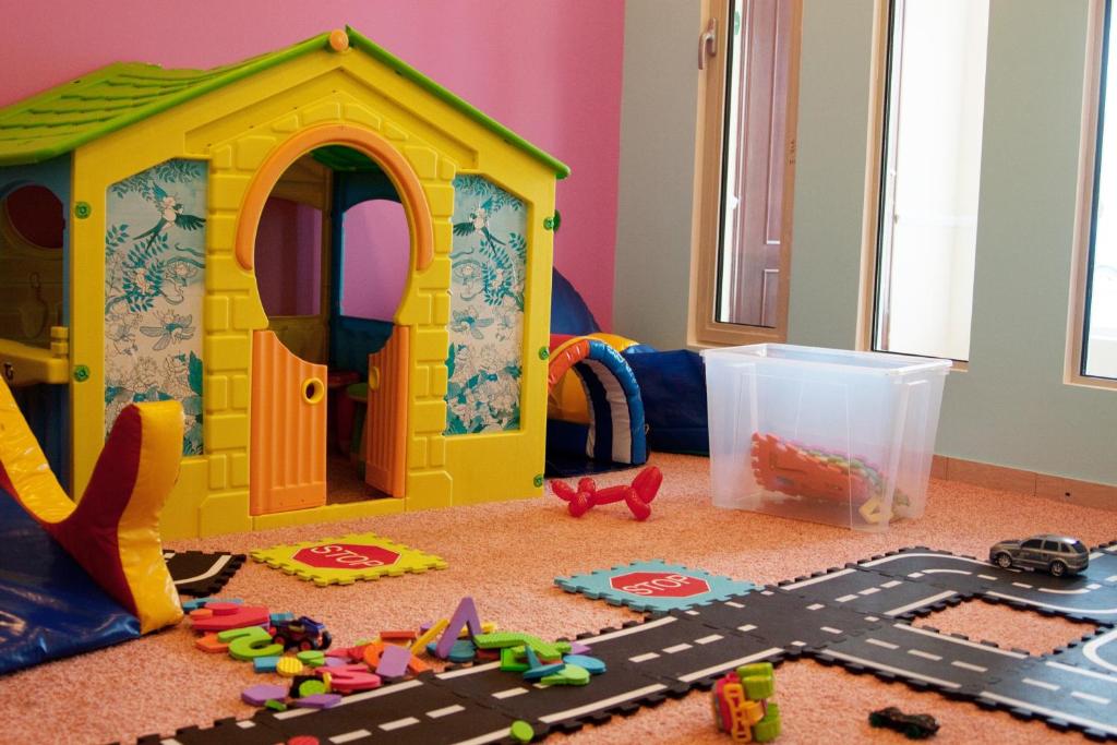 a toy dog house and toys on the floor at Grand Peterhof Spa Hotel in Petergof
