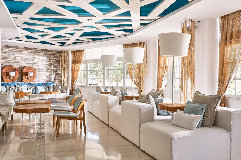 
a living room filled with furniture and a large window at Kythnos Bay Hotel in Loutra
