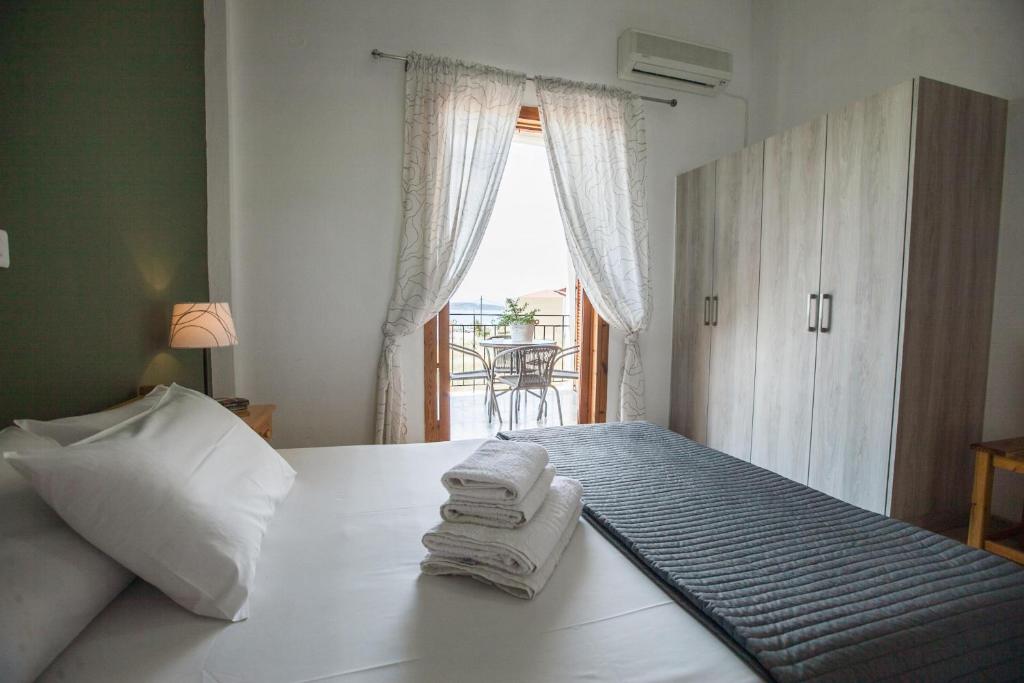 a hotel room with a bed with towels on it at Sofia Apartments - Kantia in Kandia