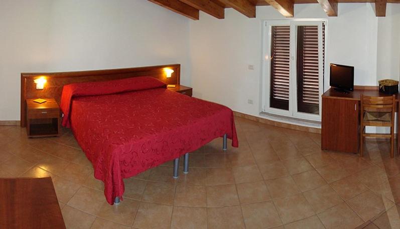 Postel nebo postele na pokoji v ubytování Albergo Antica Luni