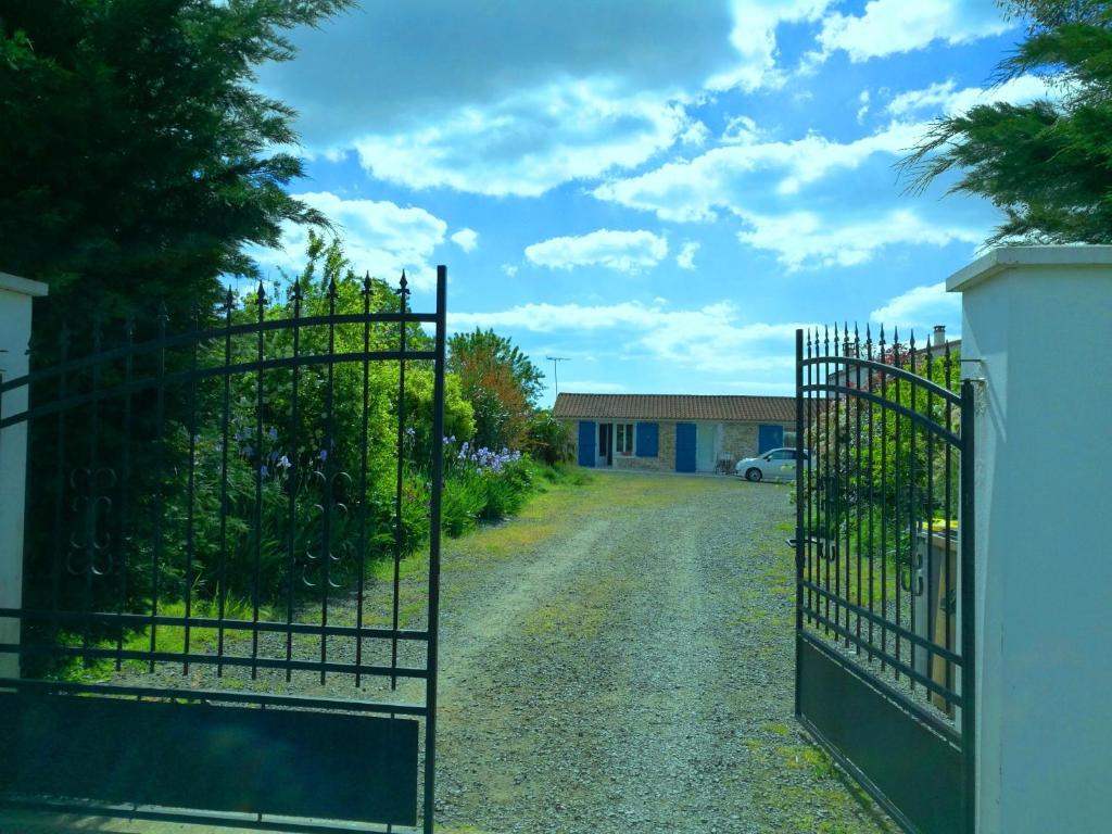 a gate to a driveway in front of a house at La Sornière in Talmont