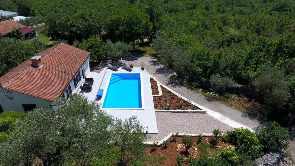 an aerial view of a house with a swimming pool at Vacation Home Daniela in Žgaljić