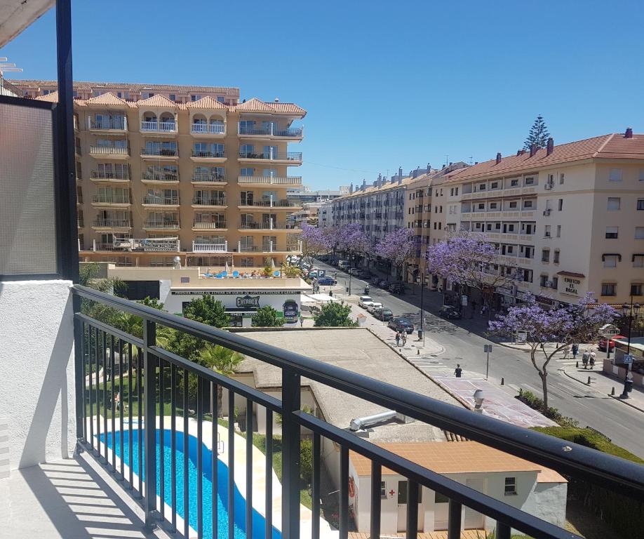 a view from the balcony of a building with a swimming pool at Cosy flat near the beach & town centre in Fuengirola