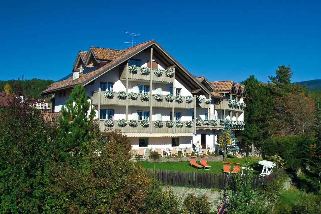 a large building with balconies on the side of it at Hotel Dolomitenblick in Collalbo