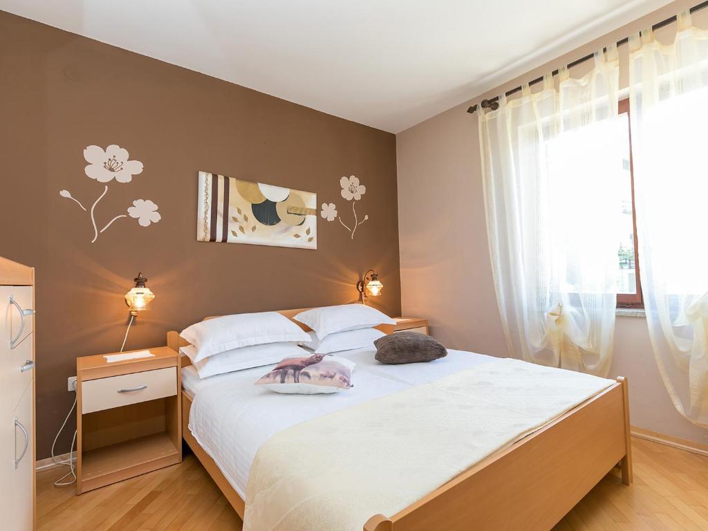 Postel nebo postele na pokoji v ubytování Apartments Nada