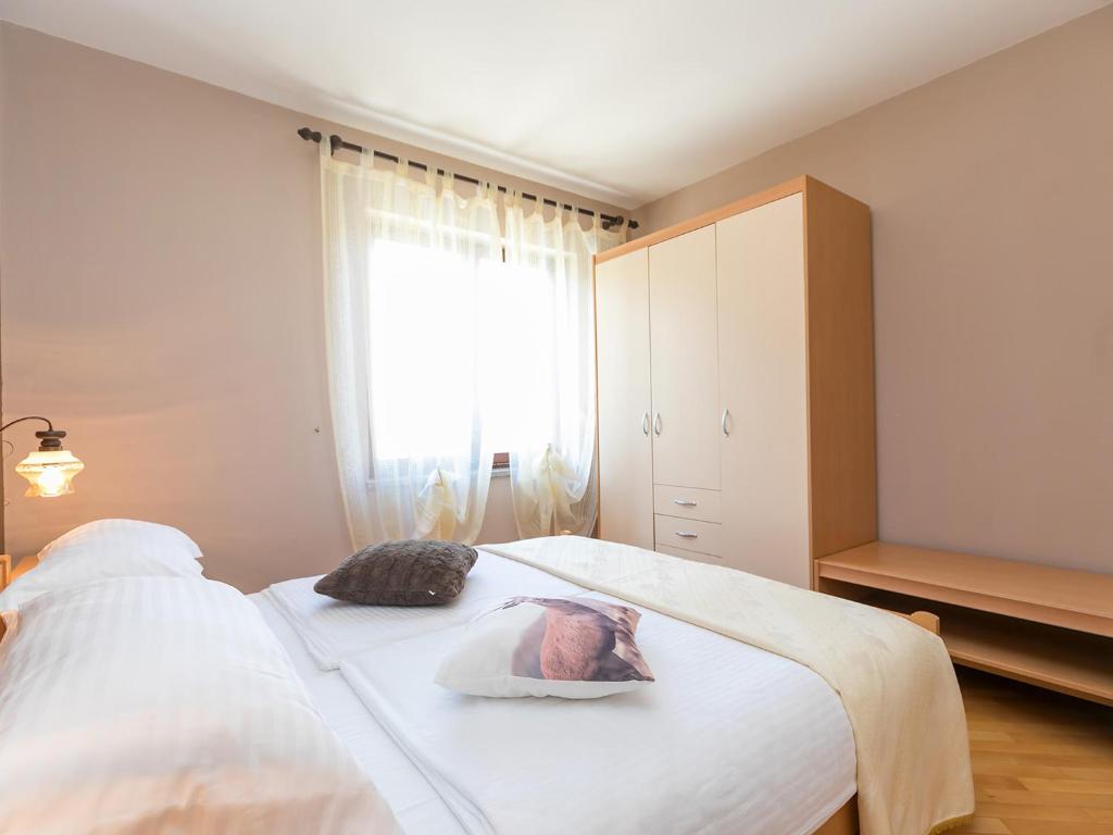Postel nebo postele na pokoji v ubytování Apartments Nada