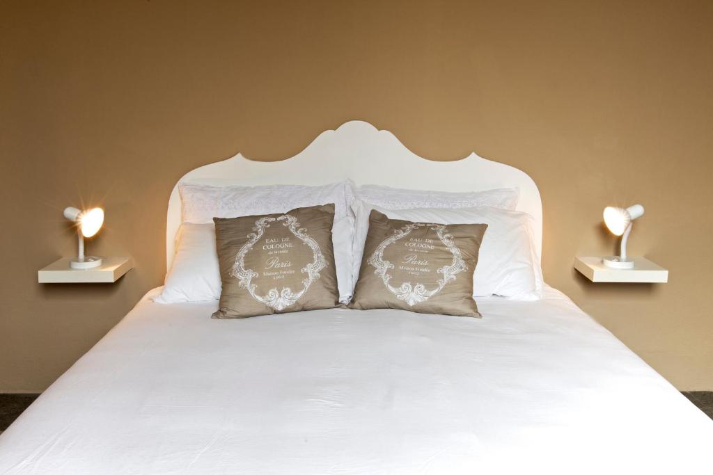 Łóżko lub łóżka w pokoju w obiekcie BluLassù City Center Rooms