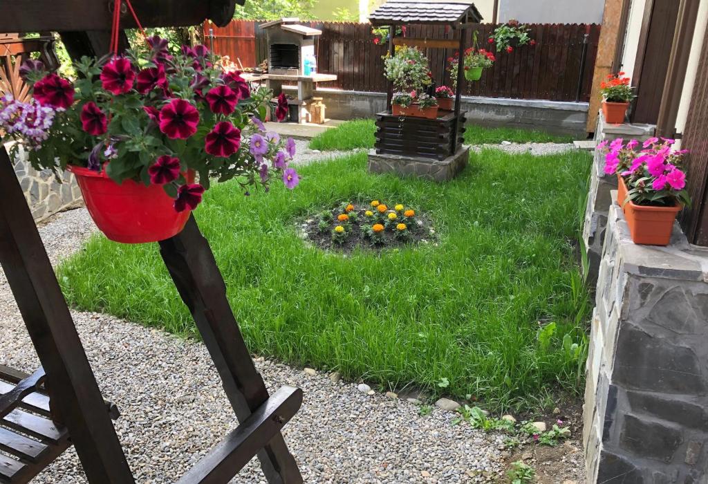 a flower pot on a stand in a garden at Chez Marcel Sinaia in Sinaia