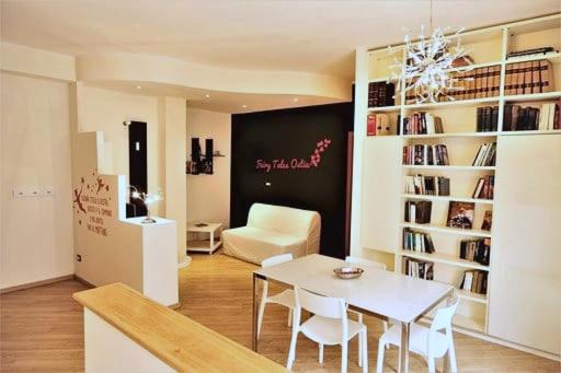 a living room with a table and a chair at Fairy Tales Ostia in Lido di Ostia