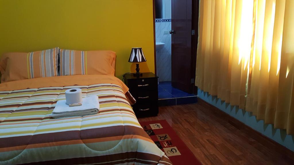 Postel nebo postele na pokoji v ubytování Hostal Los Pinos