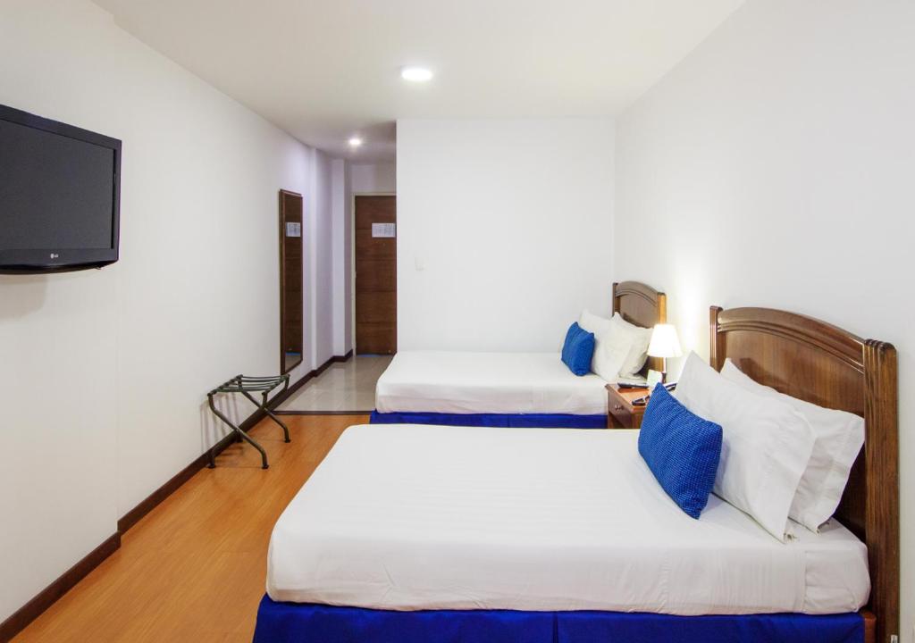 Postel nebo postele na pokoji v ubytování Pop Art Hotel Las Colinas Manizales