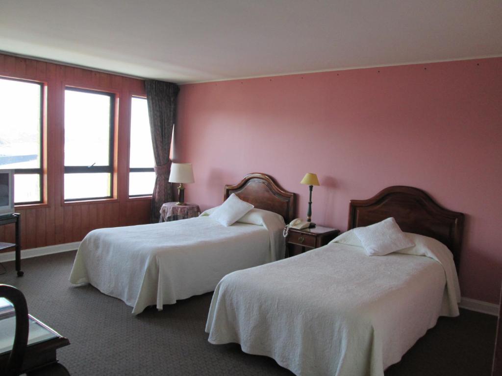 Postel nebo postele na pokoji v ubytování Hotel Apart Colón