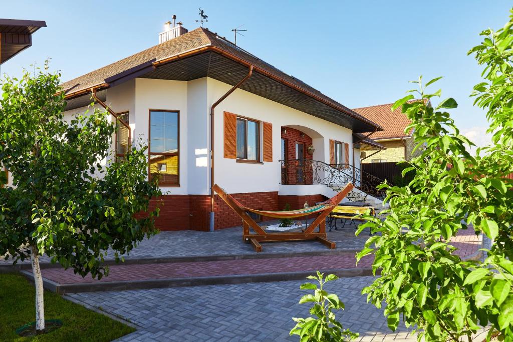 a house with a hammock in front of it at Usadba 12 Stulev in Tarasovo