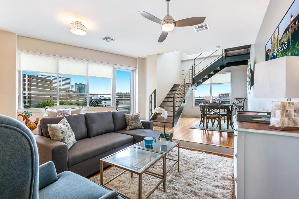 a living room with a couch and a table at California Building by Hosteeva in New Orleans