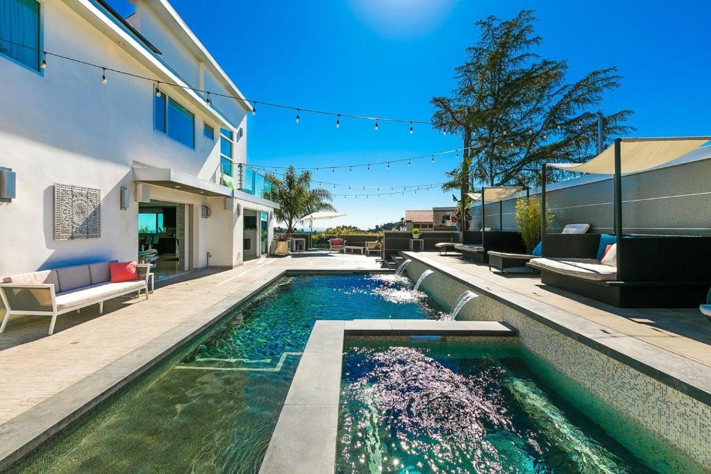 a swimming pool in the backyard of a house at Villa Genesis-HOLLYWOOD ESTATE WITH STUNNING VIEWS in Los Angeles