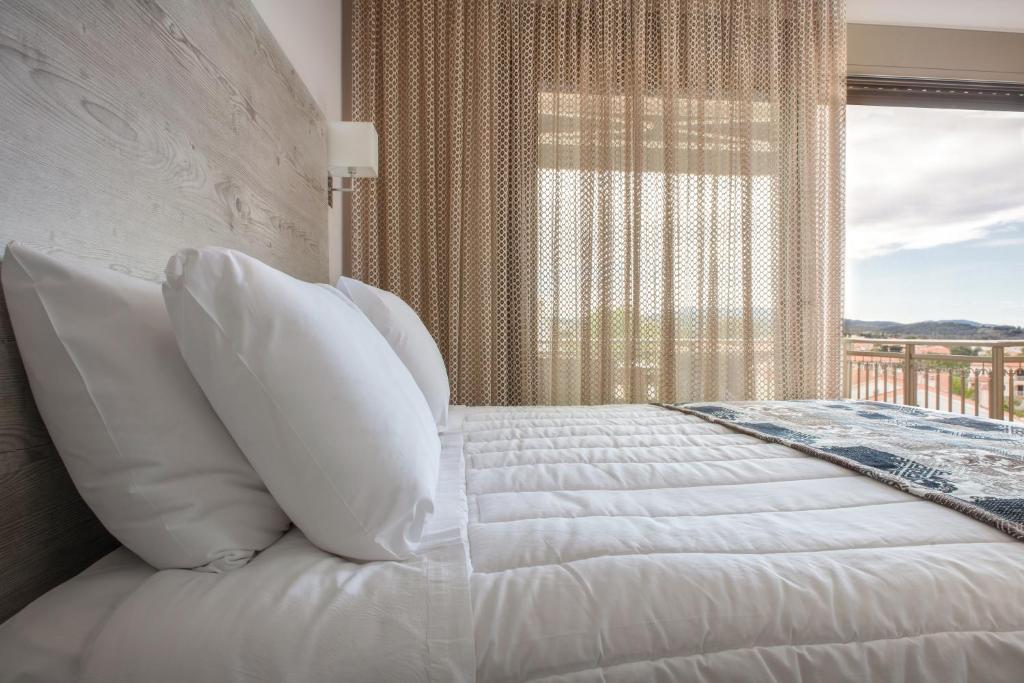 Posteľ alebo postele v izbe v ubytovaní Royalty Suites Loft