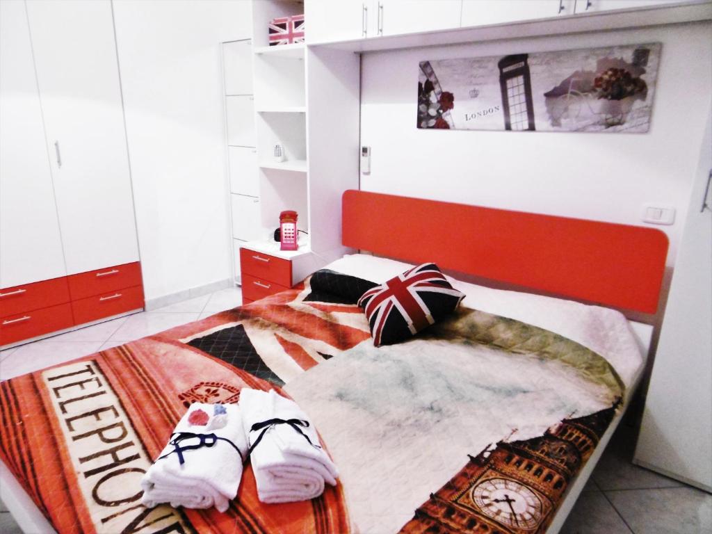 波爾托雷卡納蒂的住宿－LONDON BY SEA，一间卧室配有带毛巾的床