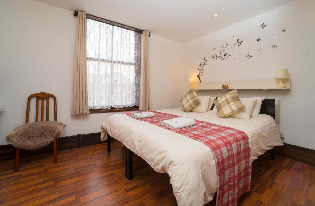 a bedroom with a bed and a window with stars on the wall at Breeze Guest House in Bootle