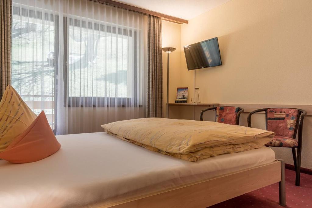 Postel nebo postele na pokoji v ubytování Hotel Alex