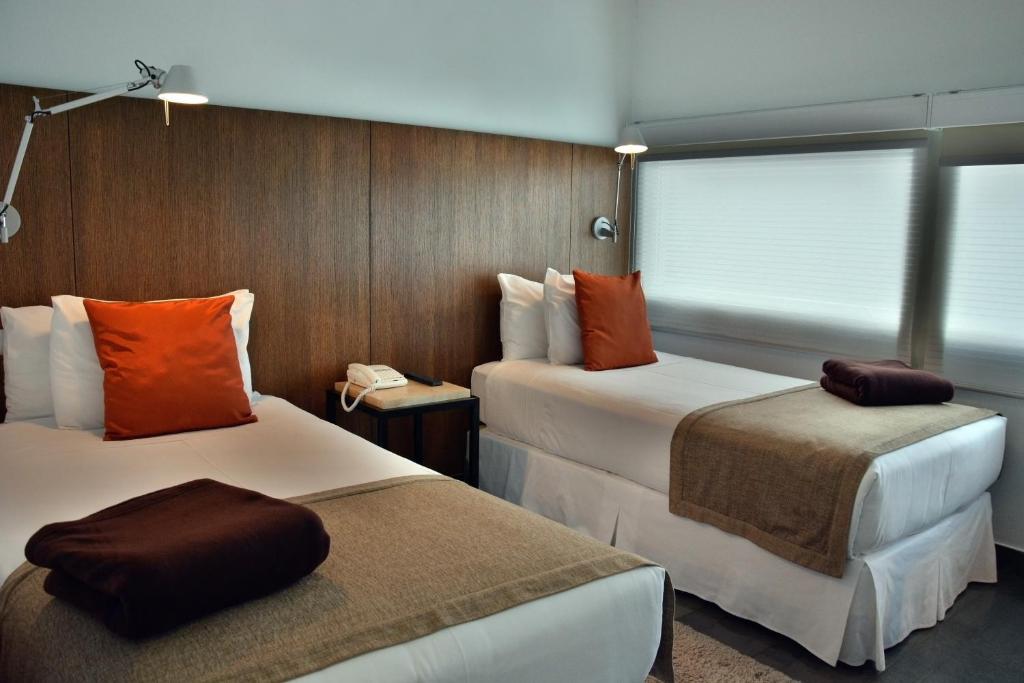 Postel nebo postele na pokoji v ubytování Natalino Hotel Patagonia