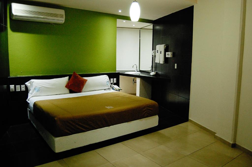 Postel nebo postele na pokoji v ubytování Hotel Porto Novo