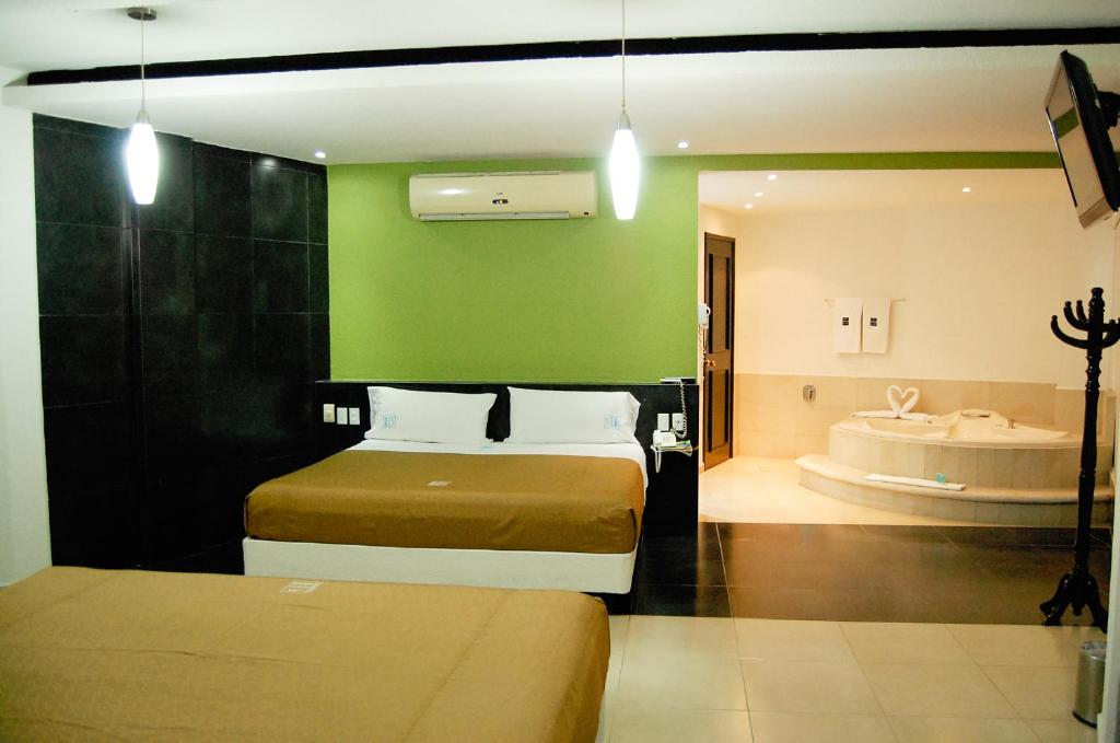 Postel nebo postele na pokoji v ubytování Hotel Porto Novo