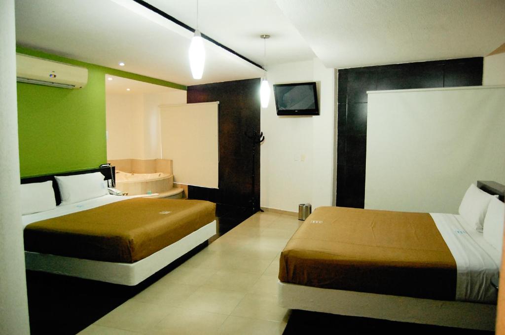 Postel nebo postele na pokoji v ubytování Hotel Porto Novo