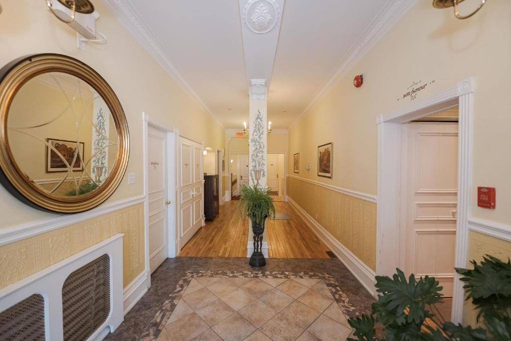 a hallway of a home with a mirror on the wall at Manoir Sherbrooke in Montréal