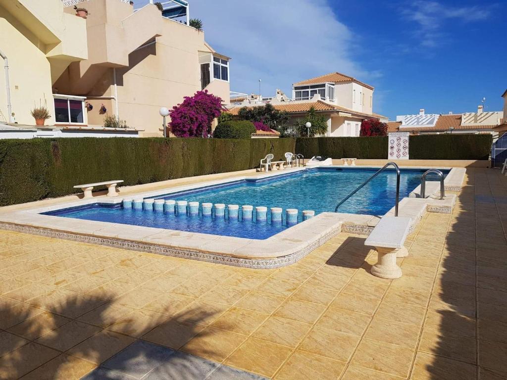 a swimming pool in front of a house at Casa La Florida in Orihuela
