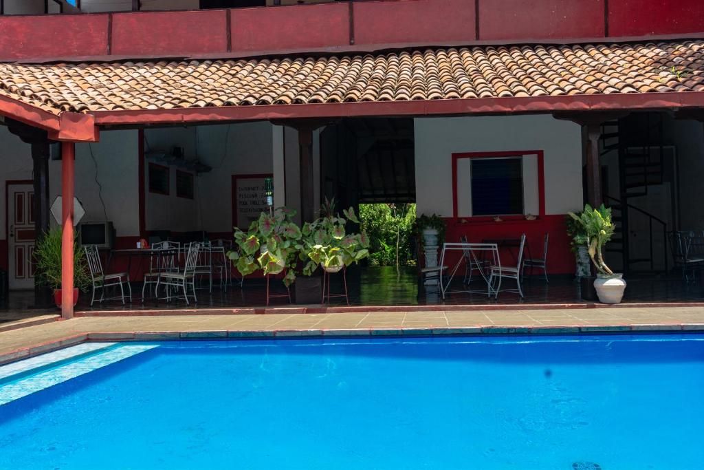 a swimming pool in front of a house at Hostal Lazybones in León