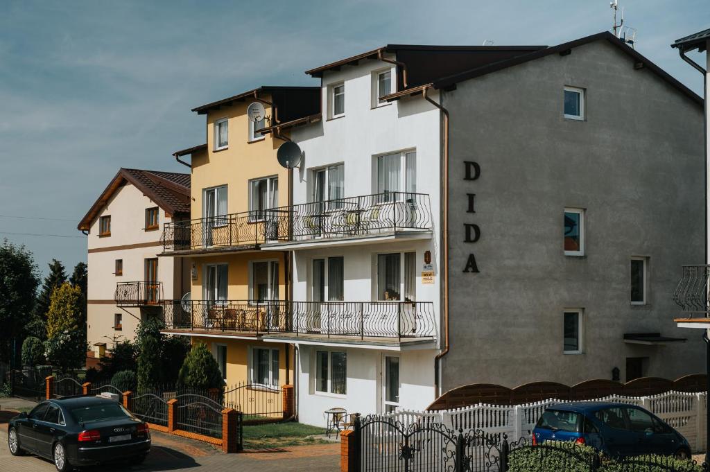 a large building with cars parked in front of it at DIDA in Ostrowo