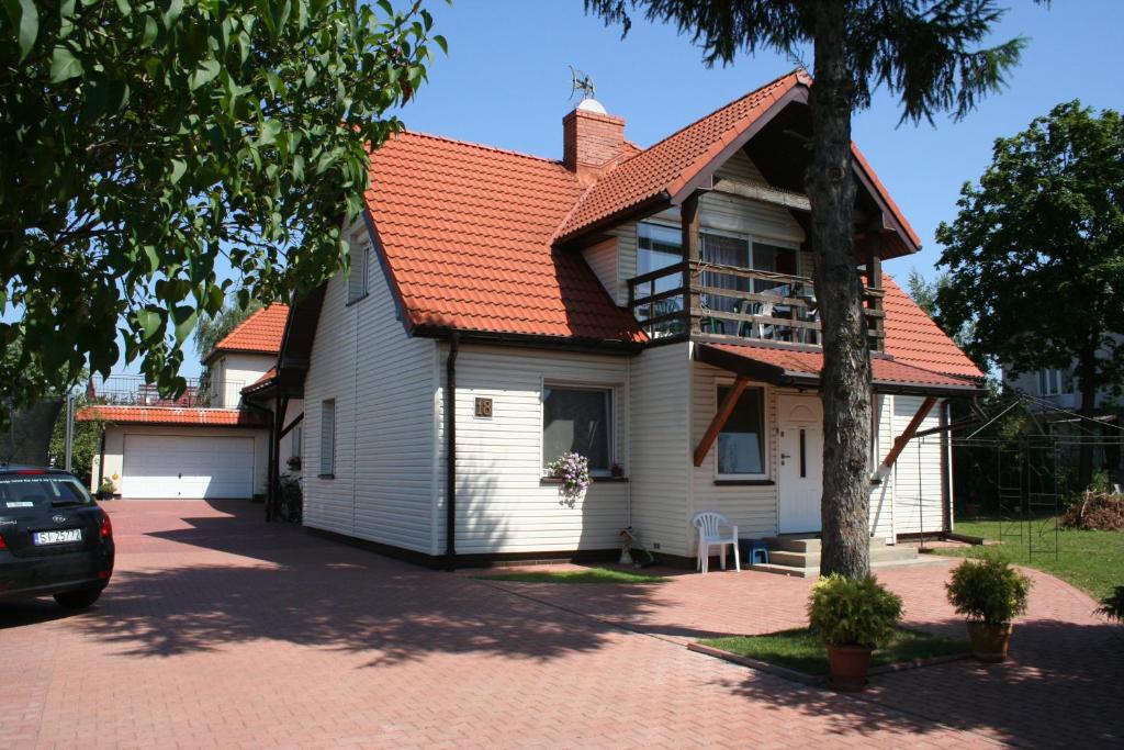 a white house with an orange roof at U pani Ani Żeglarska 18 in Augustów